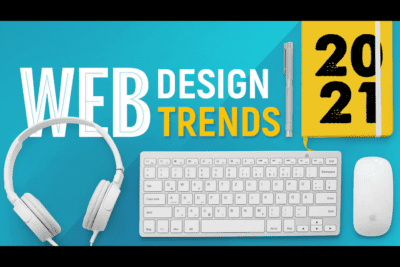 Modern web design trends for 2021, featuring a keyboard, headphones, and a planner.