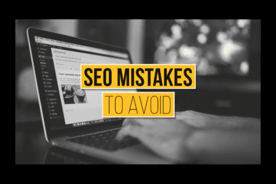 Person working on a laptop with SEO mistakes warning overlay.
