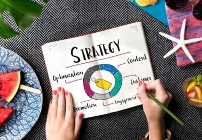 Planning SEO strategies with a notebook and colorful summer items on a table.