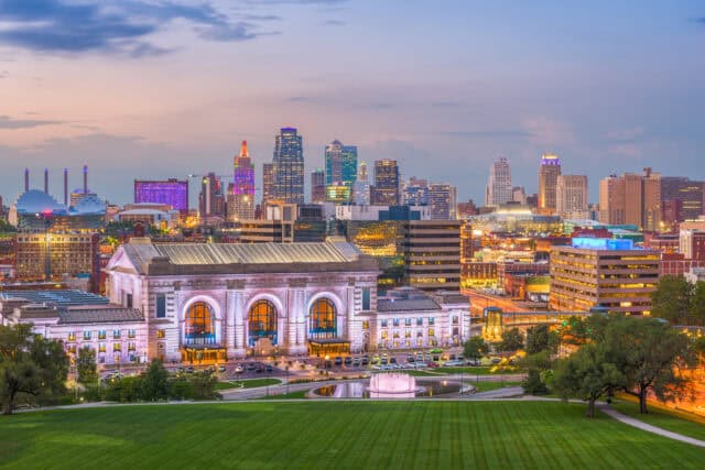 Kansas City skyline with Union Station illuminated at sunset.